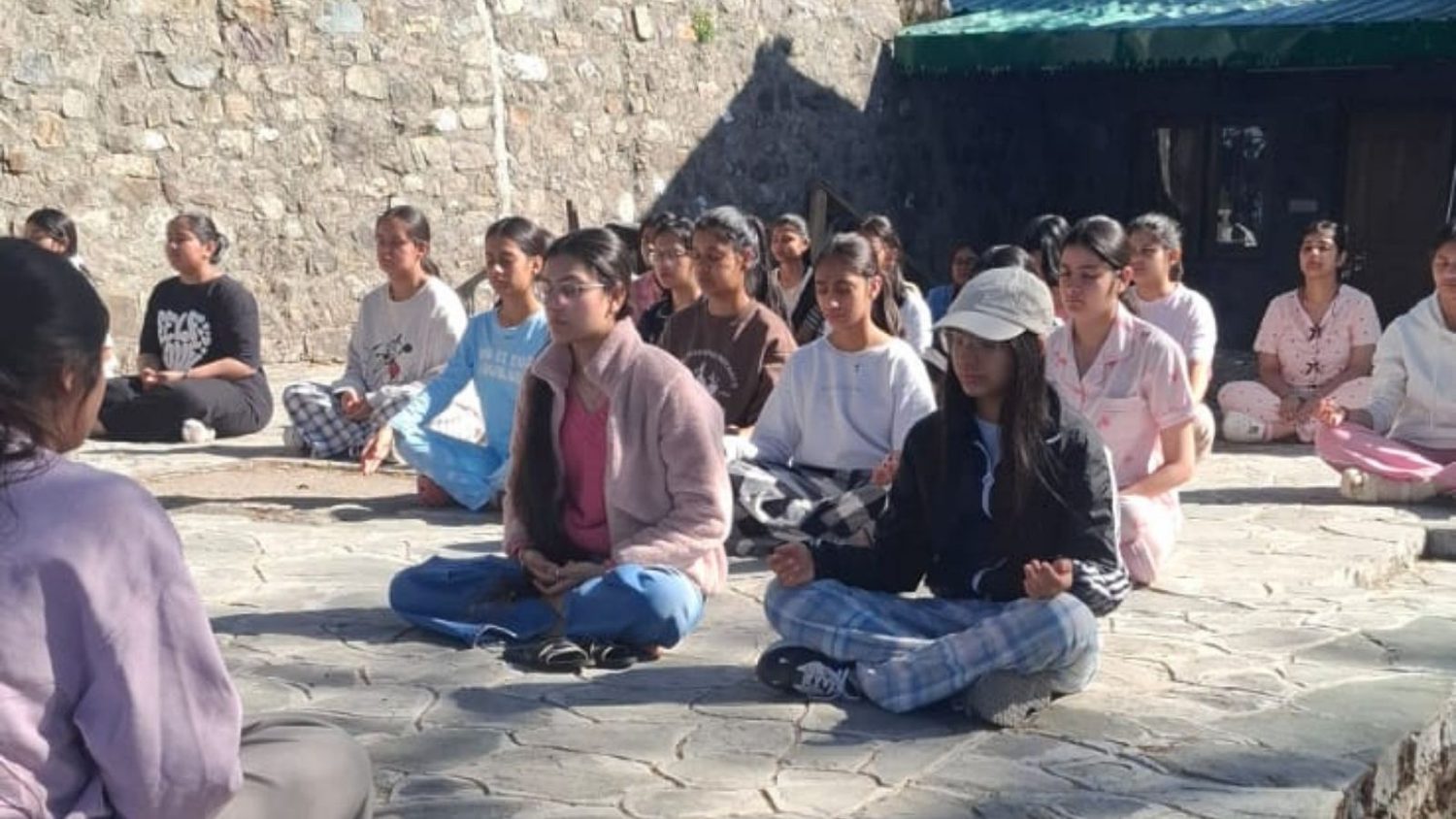 Participants sitting outdoors in a guided reflection practice